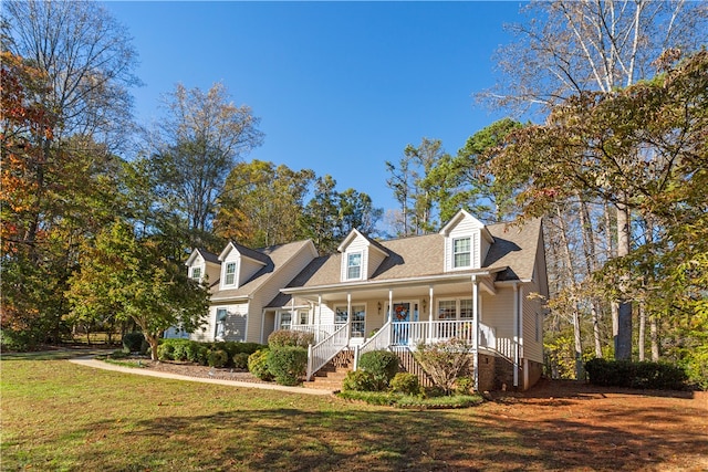 cape cod home featuring a front lawn and a porch