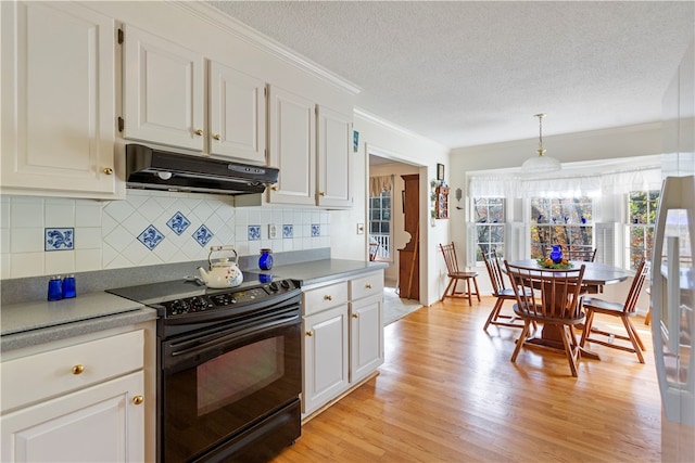 kitchen featuring black electric range oven, a textured ceiling, decorative light fixtures, light hardwood / wood-style floors, and white cabinetry