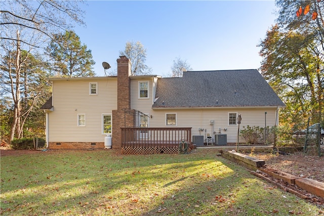 rear view of house with a wooden deck, a yard, and central AC