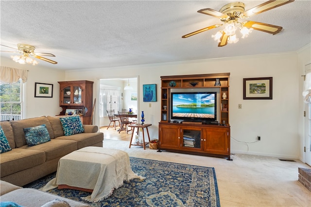 carpeted living room featuring ceiling fan, crown molding, and a textured ceiling