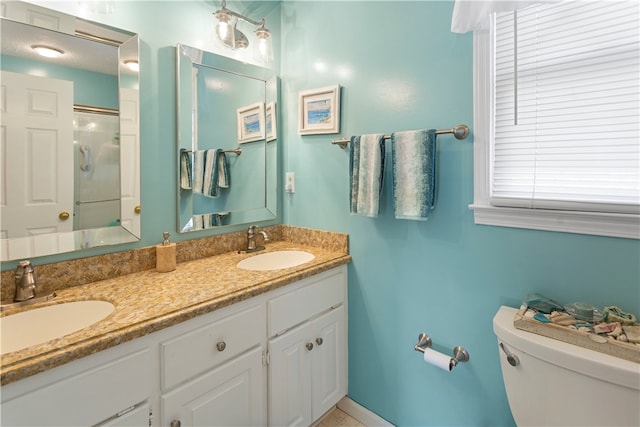 bathroom with vanity, toilet, and walk in shower