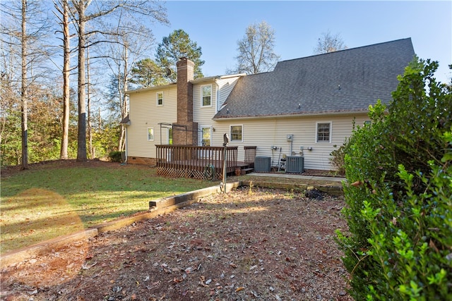 back of house with a lawn, a deck, and central air condition unit