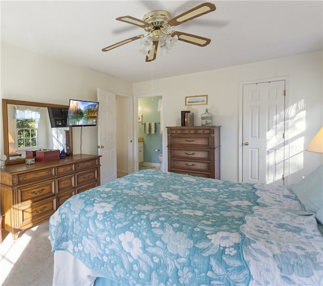 carpeted bedroom with ceiling fan and ensuite bathroom