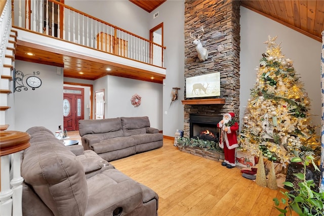 living room with wood ceiling and high vaulted ceiling