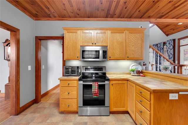 kitchen featuring appliances with stainless steel finishes, tile countertops, wooden ceiling, and light tile patterned flooring