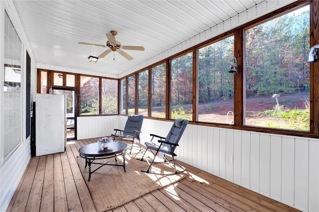 unfurnished sunroom with ceiling fan