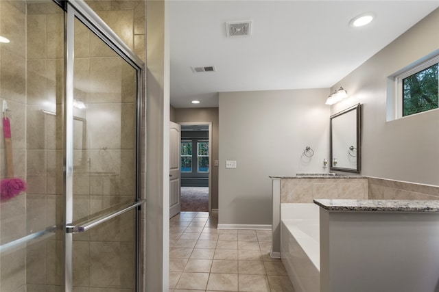 bathroom featuring tile patterned flooring and independent shower and bath