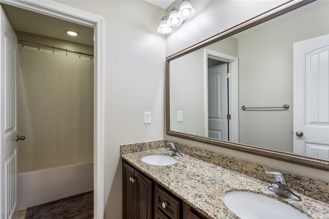 bathroom featuring shower / bath combo with shower curtain and vanity