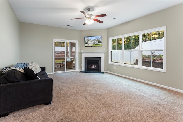 living room featuring carpet flooring and ceiling fan