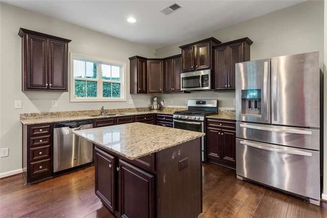 kitchen with a center island, stainless steel appliances, dark hardwood / wood-style floors, and sink