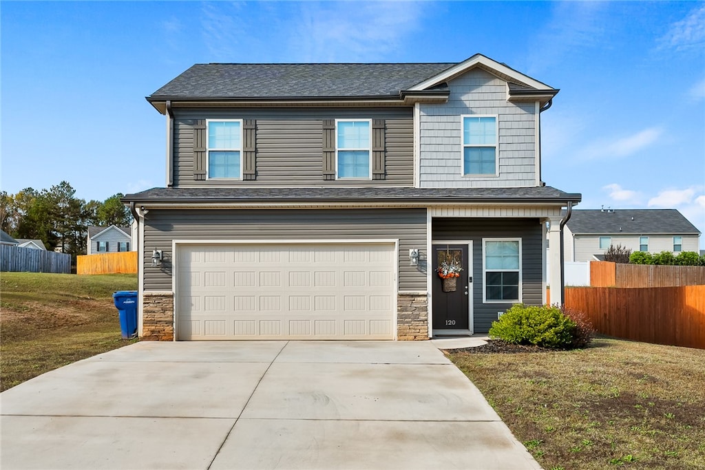 view of front of home with a garage and a front lawn