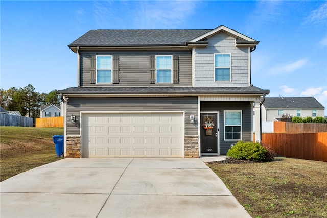 view of front of home with a garage and a front lawn