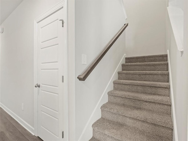 staircase featuring hardwood / wood-style floors