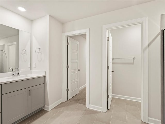 bathroom featuring vanity, a shower with door, and tile patterned floors