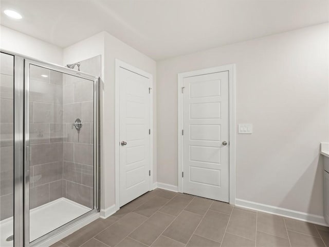 bathroom with vanity, an enclosed shower, and tile patterned flooring