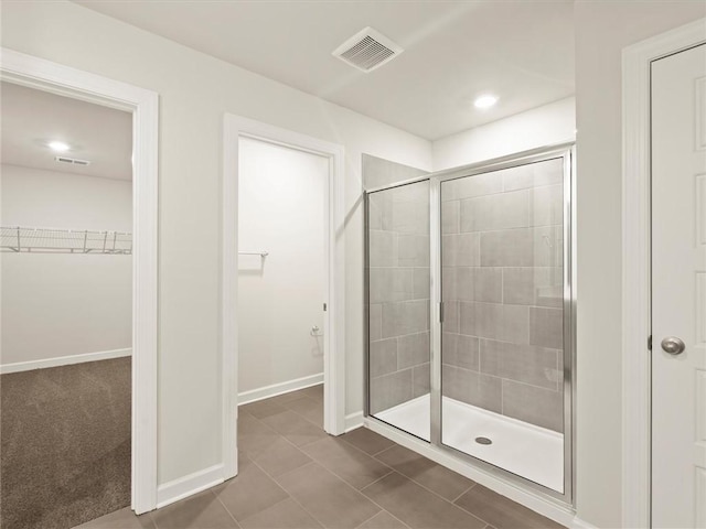 bathroom featuring tile patterned flooring and an enclosed shower