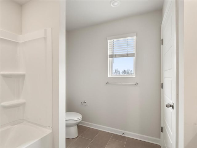 bathroom with tile patterned floors, toilet, and tub / shower combination