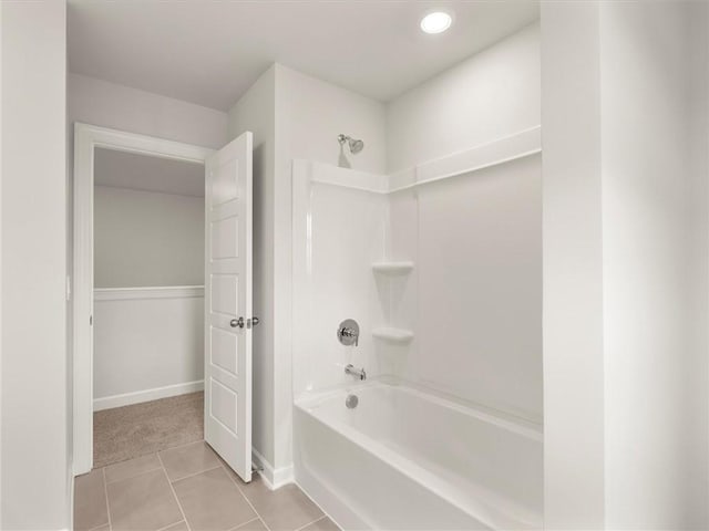 bathroom with tile patterned floors and washtub / shower combination