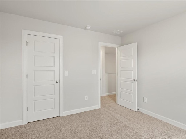 unfurnished bedroom featuring light colored carpet