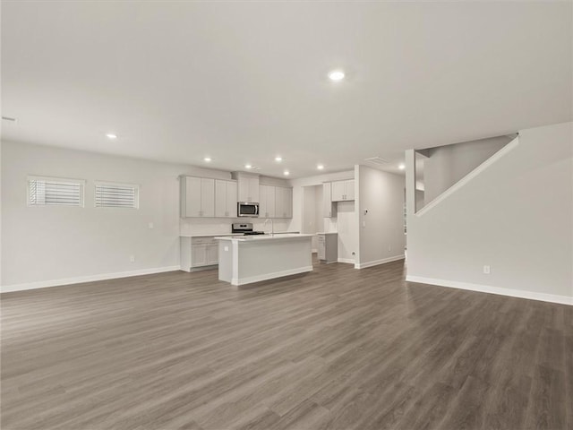 unfurnished living room featuring wood-type flooring