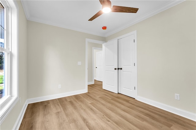 unfurnished bedroom featuring ceiling fan, light hardwood / wood-style floors, and crown molding