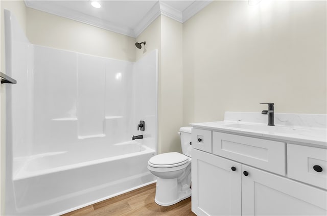 full bathroom featuring ornamental molding, bathtub / shower combination, vanity, wood-type flooring, and toilet