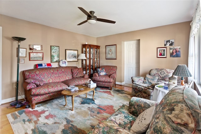 living room featuring ceiling fan and wood-type flooring