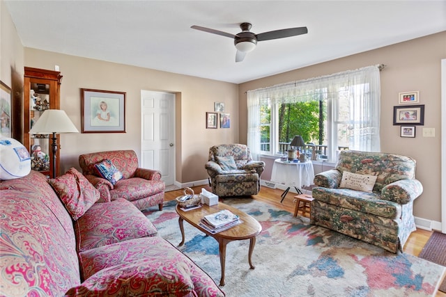 living room featuring hardwood / wood-style flooring and ceiling fan