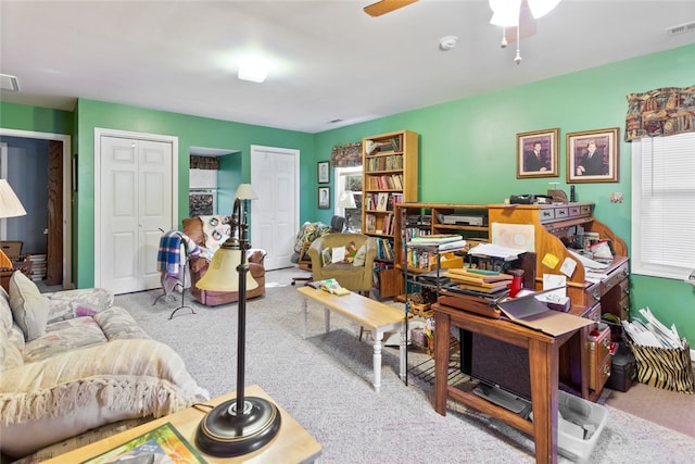 office area with ceiling fan and light carpet