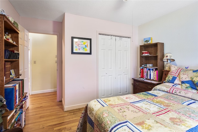 bedroom featuring light hardwood / wood-style flooring and a closet