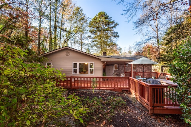 rear view of property with a wooden deck