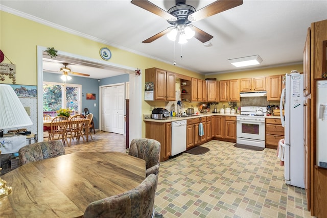 kitchen featuring backsplash, sink, white appliances, and crown molding