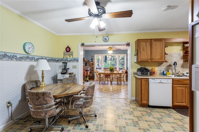 kitchen featuring white dishwasher, ornamental molding, and sink