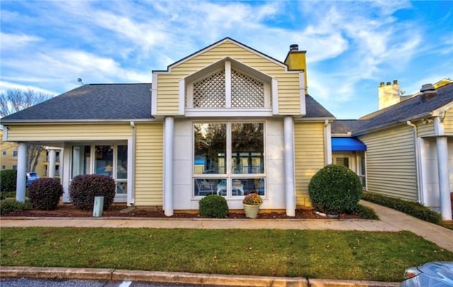 rear view of house with a lawn