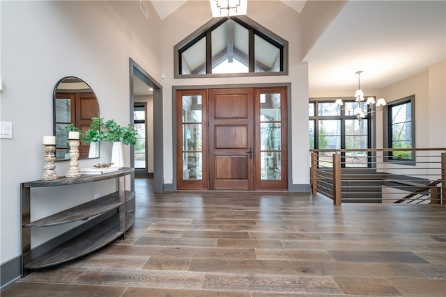 entryway featuring a notable chandelier, dark hardwood / wood-style floors, and high vaulted ceiling