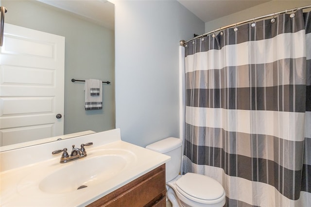 bathroom with vanity, toilet, and walk in shower