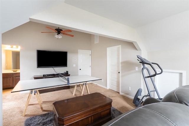 carpeted living room featuring ceiling fan and vaulted ceiling