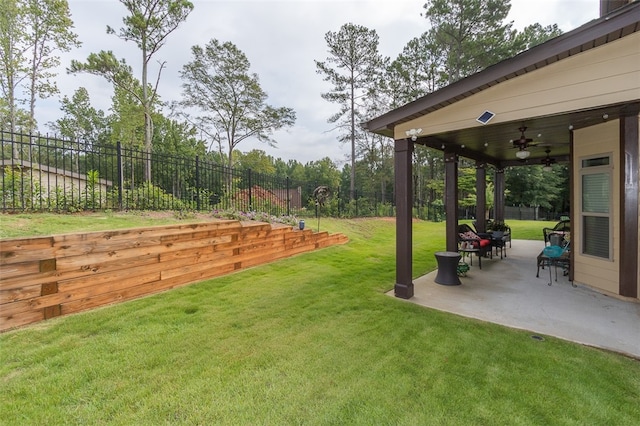 view of yard with ceiling fan and a patio