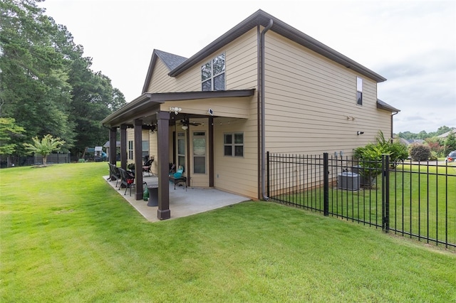 back of house with a patio area and a yard