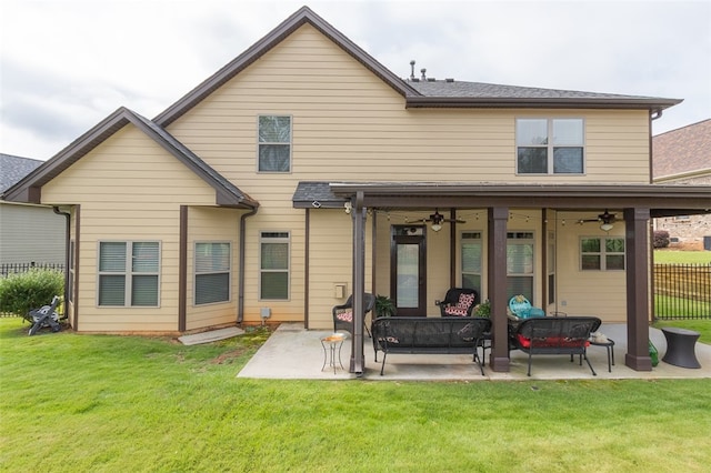 back of property with outdoor lounge area, a yard, a patio, and ceiling fan