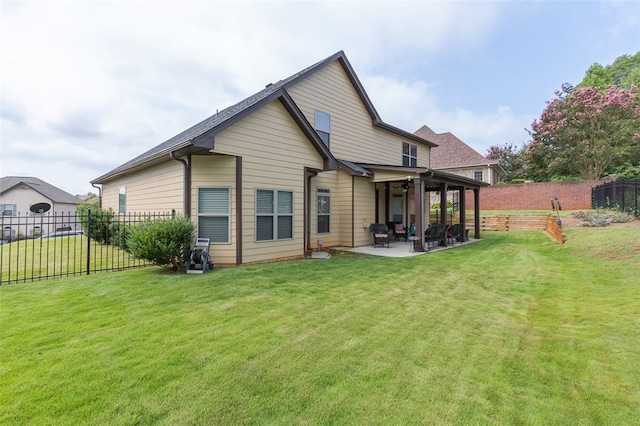 back of house featuring ceiling fan, a yard, and a patio