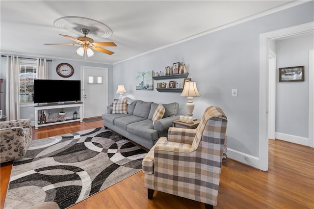 living room with hardwood / wood-style floors, ceiling fan, and crown molding