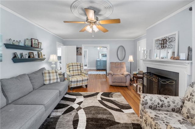 living room with light wood-type flooring and ornamental molding