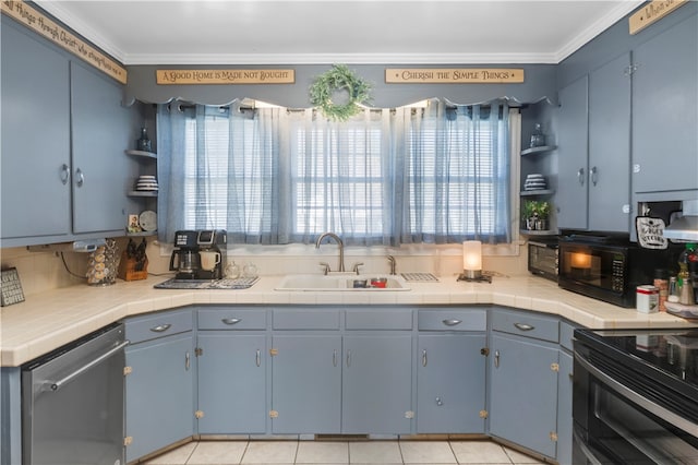 kitchen with a wealth of natural light, tile counters, and sink