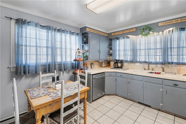 kitchen featuring dishwasher, plenty of natural light, ornamental molding, and sink