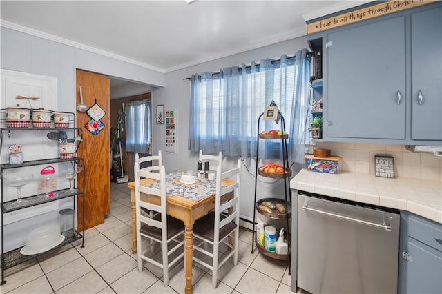 kitchen featuring tasteful backsplash, blue cabinets, dishwasher, tile counters, and light tile patterned flooring