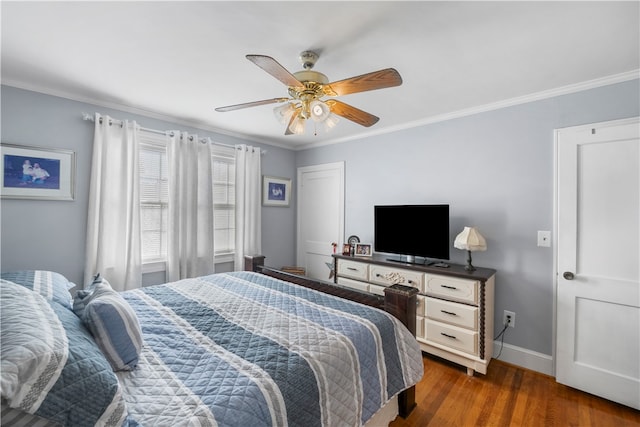 bedroom with dark hardwood / wood-style flooring, ceiling fan, and ornamental molding