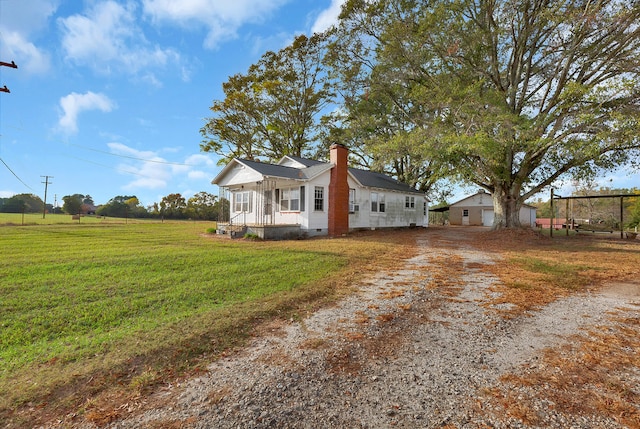 view of side of property featuring a yard and a porch