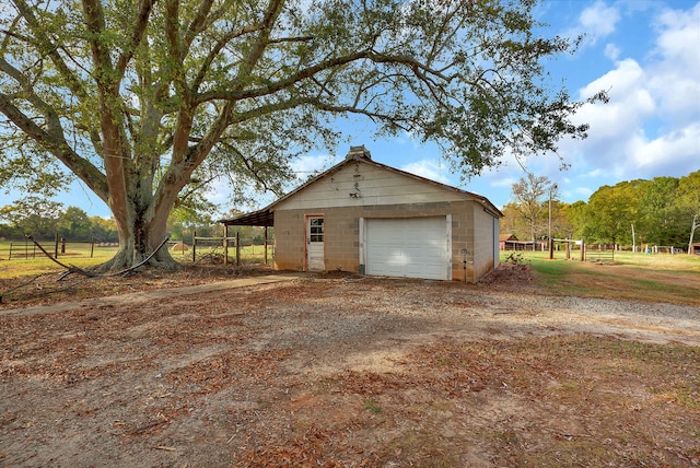 garage featuring a rural view