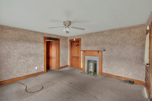 unfurnished living room featuring light carpet and ceiling fan